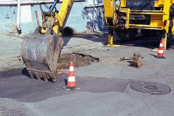 Excavator digging groundworks for drainage installation